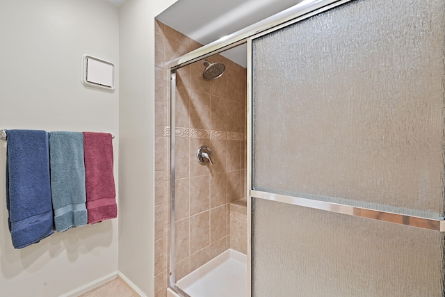 bathroom with tile patterned flooring and walk in shower