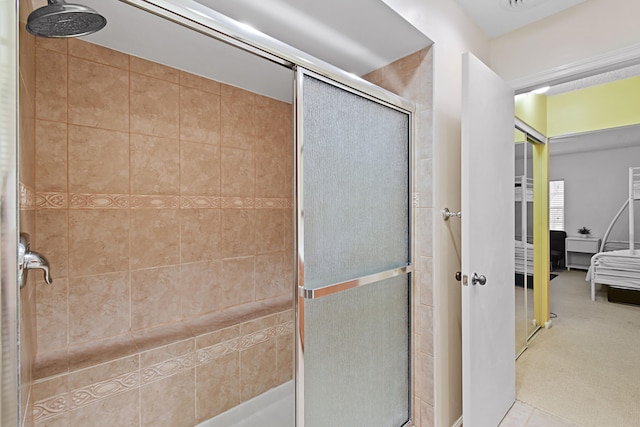 bathroom featuring walk in shower and tile patterned floors