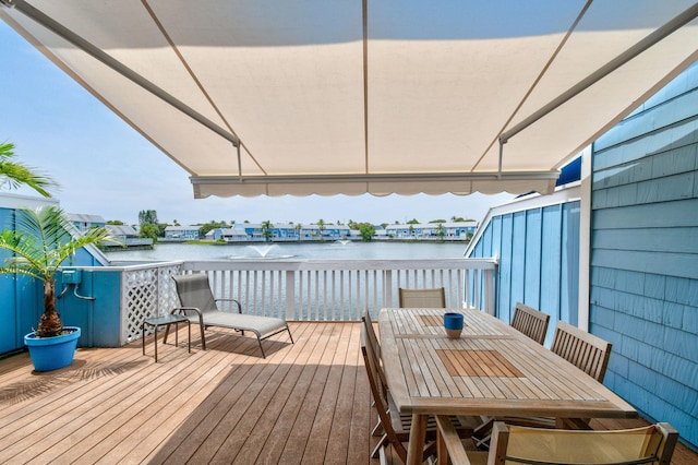 wooden terrace featuring a water view