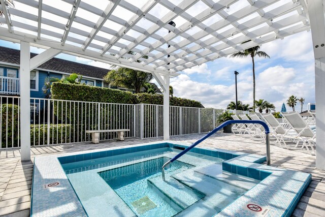 view of swimming pool with a pergola and a hot tub