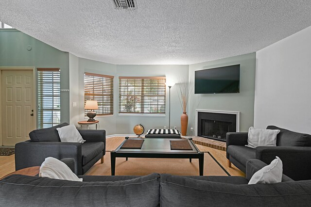 living room featuring light hardwood / wood-style floors and a textured ceiling