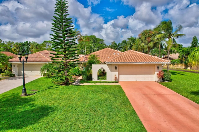 mediterranean / spanish house with a front lawn and a garage