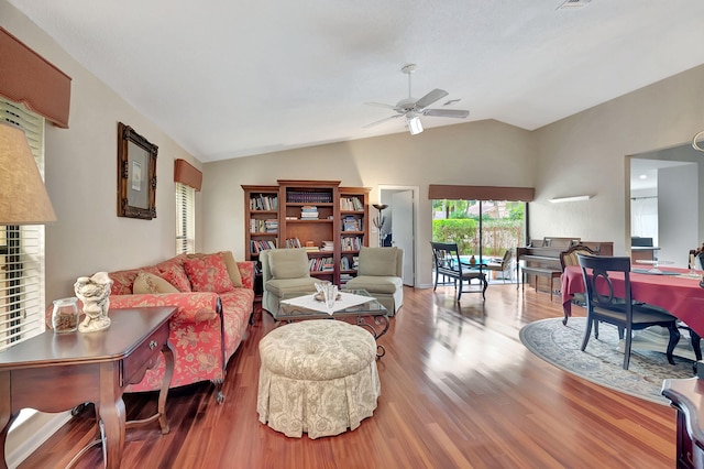 living room featuring hardwood / wood-style floors, vaulted ceiling, and ceiling fan