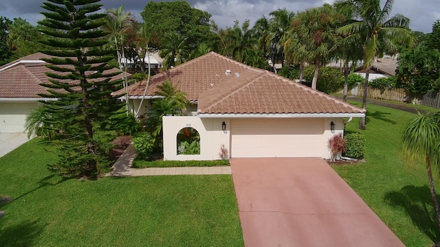 mediterranean / spanish-style house with a front yard and a garage