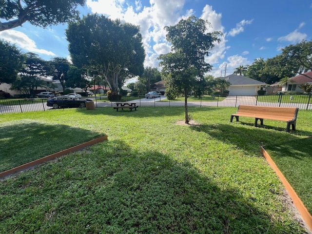 view of property's community featuring a yard