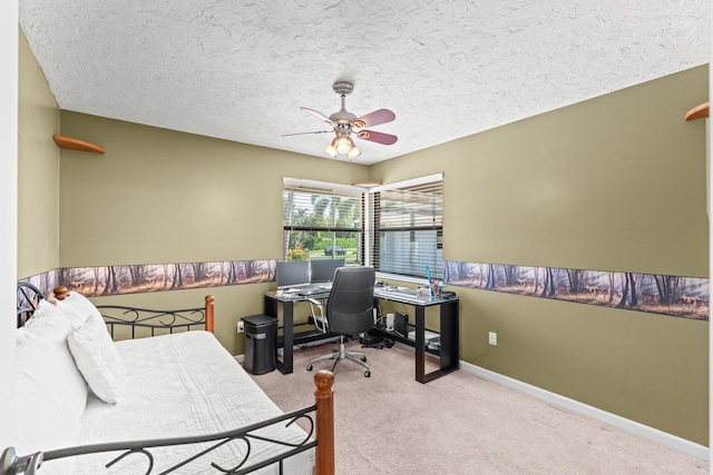 office space with baseboards, a textured ceiling, a ceiling fan, and carpet