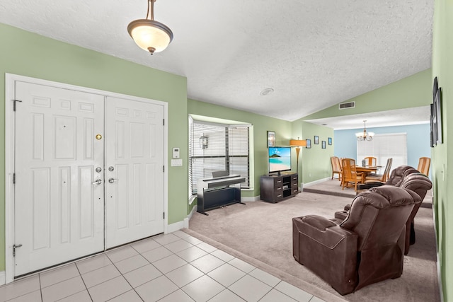 living room featuring visible vents, light colored carpet, vaulted ceiling, light tile patterned floors, and a notable chandelier