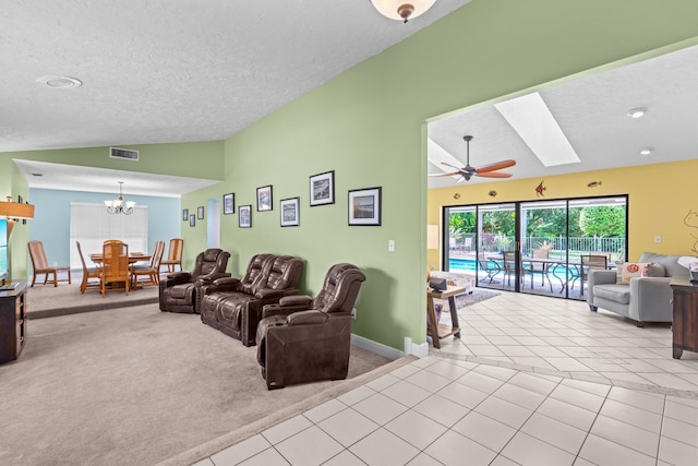 living room featuring lofted ceiling with skylight, visible vents, carpet flooring, and tile patterned floors