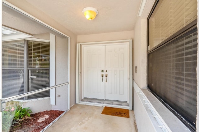 property entrance with stucco siding