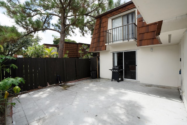 exterior space with a balcony and a patio