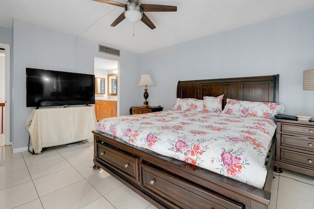 tiled bedroom featuring connected bathroom and ceiling fan