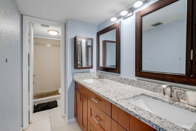 bathroom featuring vanity, toilet, tile patterned floors, and walk in shower