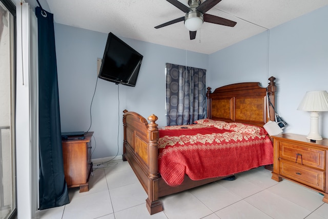 tiled bedroom with a textured ceiling and ceiling fan