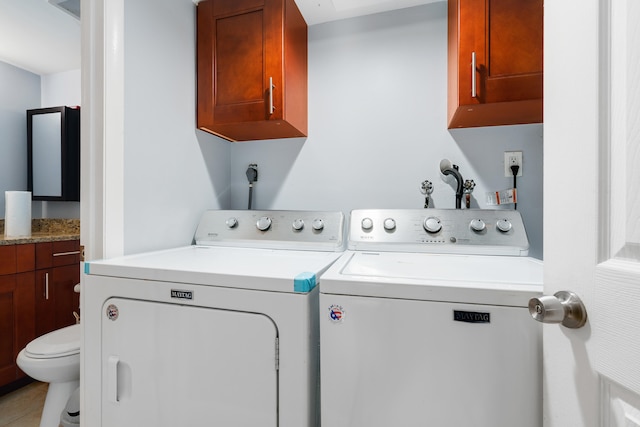 laundry room featuring cabinets, independent washer and dryer, and tile patterned flooring