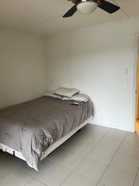 bedroom featuring tile patterned floors and ceiling fan