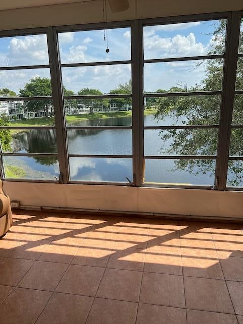 unfurnished sunroom with a water view and a healthy amount of sunlight