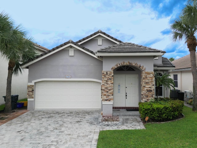 view of front of house with a garage and a front lawn