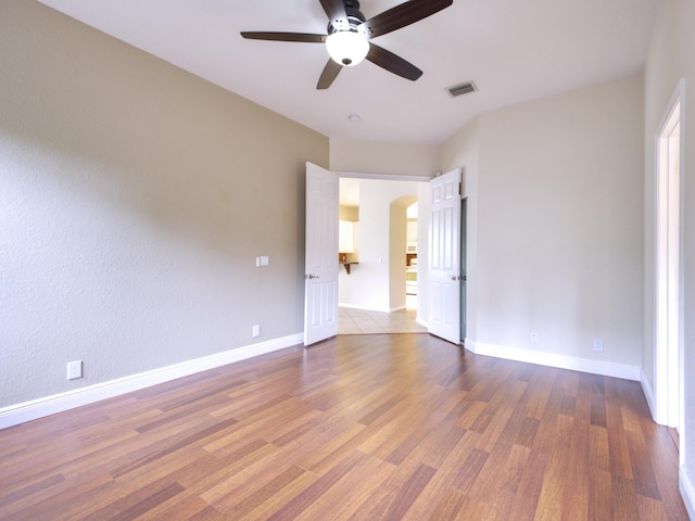 unfurnished bedroom with ceiling fan and hardwood / wood-style flooring