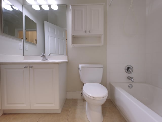 full bathroom featuring tiled shower / bath, toilet, tile patterned floors, and vanity