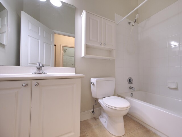 full bathroom featuring toilet, tiled shower / bath combo, vanity, and tile patterned floors