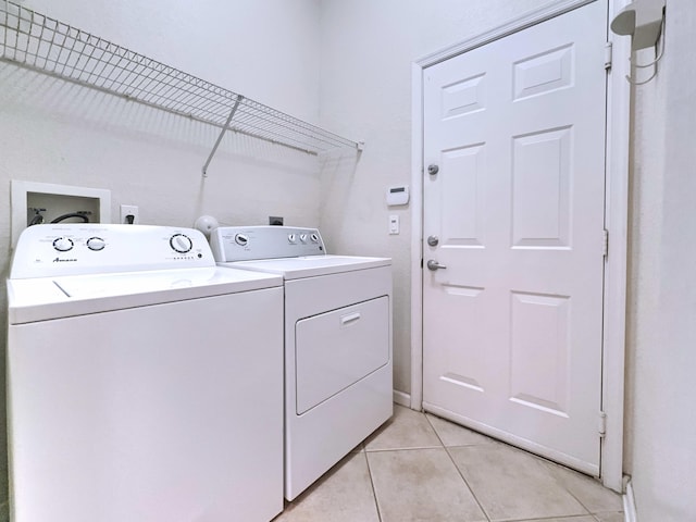 washroom with light tile patterned floors and independent washer and dryer