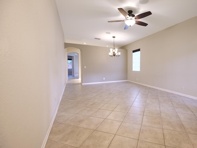 unfurnished room with ceiling fan with notable chandelier and light tile patterned flooring