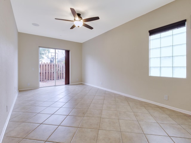 tiled empty room with ceiling fan