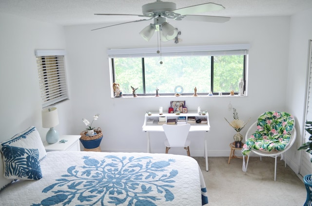 bedroom with ceiling fan, a textured ceiling, carpet floors, and multiple windows