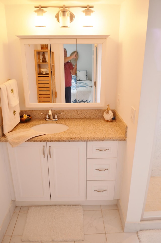 bathroom with tile patterned floors and vanity