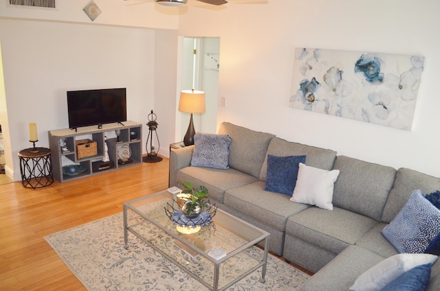 living room with ceiling fan and hardwood / wood-style floors