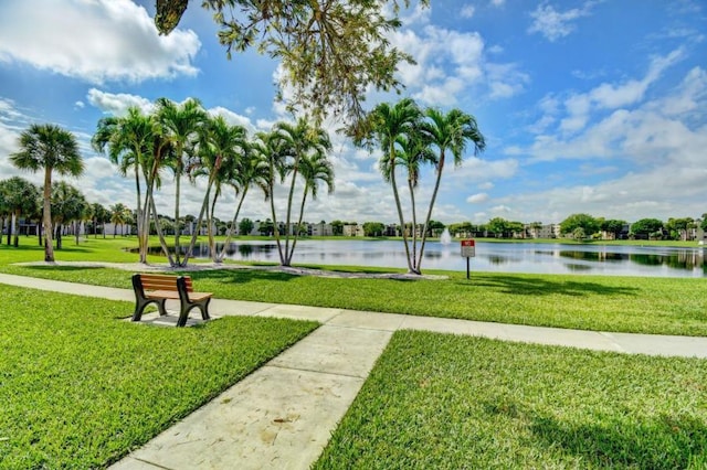 view of community with a water view and a yard