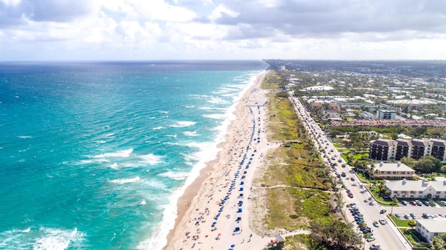 drone / aerial view with a water view and a view of the beach