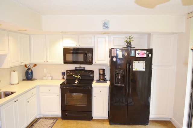 kitchen with white cabinets, light carpet, black appliances, and sink