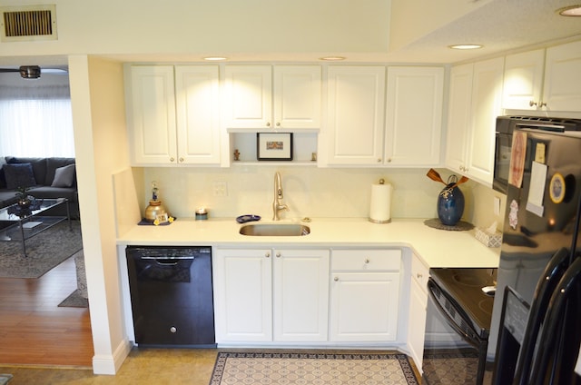 kitchen featuring light hardwood / wood-style flooring, sink, refrigerator with ice dispenser, white cabinets, and black dishwasher