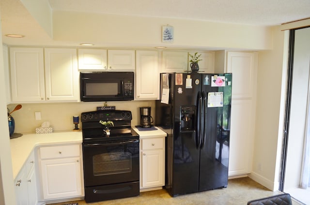 kitchen with white cabinetry, light colored carpet, and black appliances