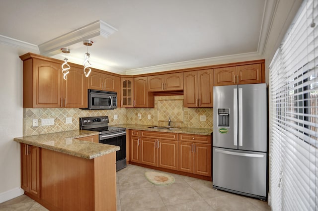 kitchen featuring appliances with stainless steel finishes, tasteful backsplash, sink, light stone countertops, and hanging light fixtures