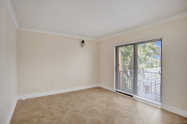 tiled spare room featuring ornamental molding