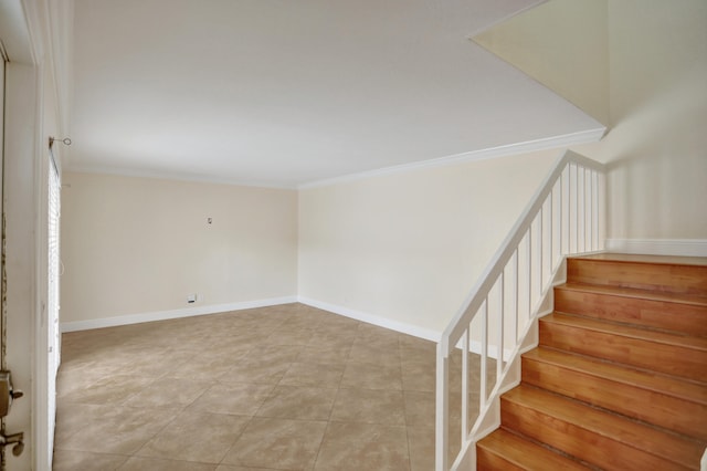 stairway with tile patterned flooring and crown molding