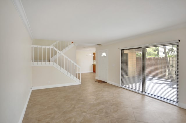 empty room with crown molding and light tile patterned flooring