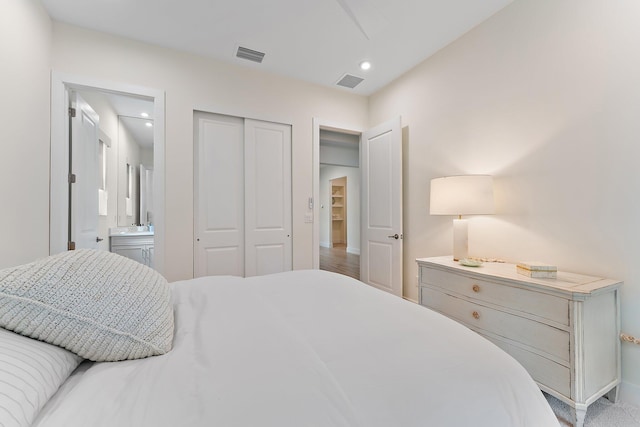 bedroom with ensuite bathroom and a closet