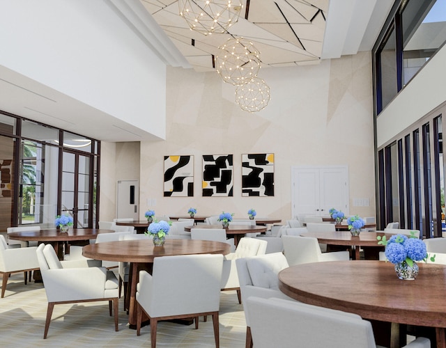 carpeted dining room featuring a high ceiling and a chandelier