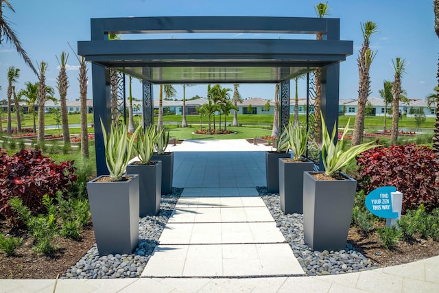 view of community featuring a lawn and a carport