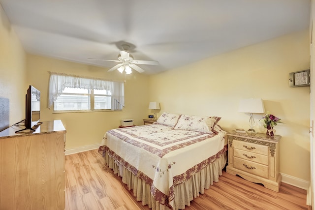 bedroom with ceiling fan and light hardwood / wood-style flooring