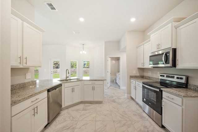 kitchen featuring kitchen peninsula, white cabinetry, sink, and appliances with stainless steel finishes