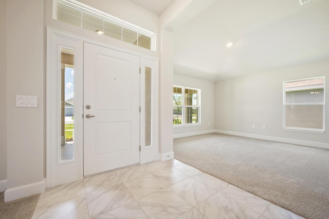 foyer with light colored carpet