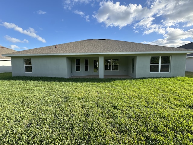 back of house featuring a lawn