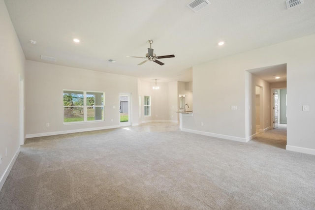 unfurnished living room with ceiling fan and light colored carpet