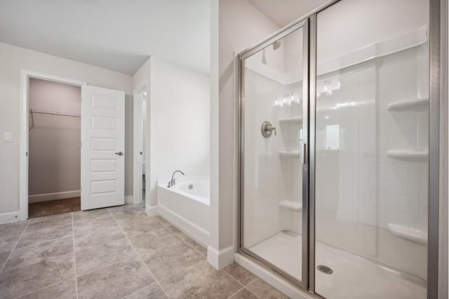 bathroom featuring tile patterned flooring and plus walk in shower