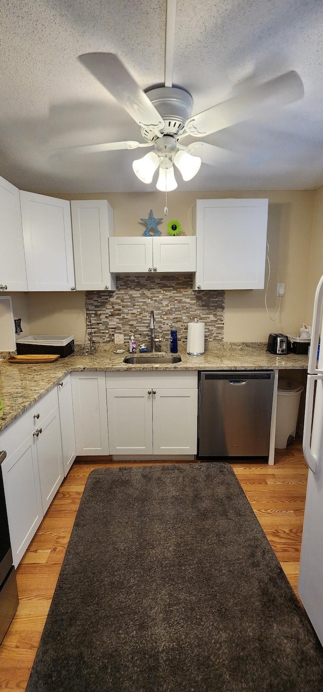 kitchen with ceiling fan, light hardwood / wood-style flooring, sink, and dishwasher