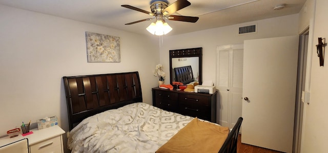 bedroom with a closet, ceiling fan, and hardwood / wood-style flooring